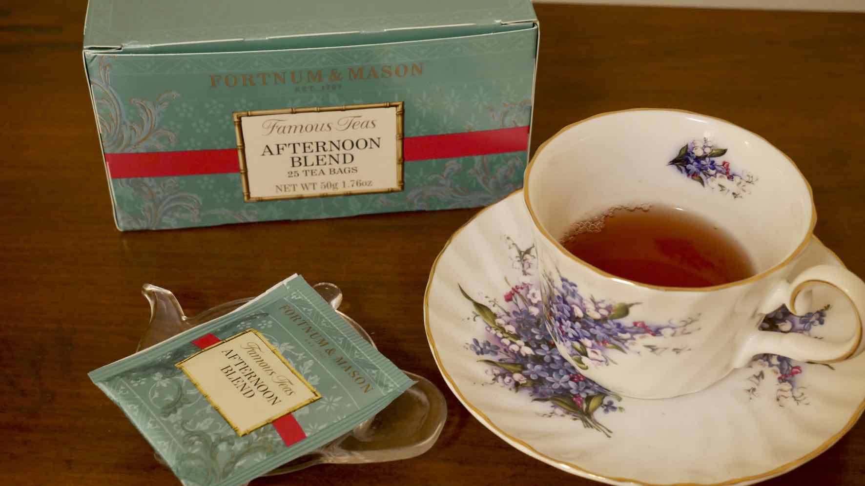 package of Fortnum & Mason's Afternoon Blend tea, teabag and cup of brewed tea