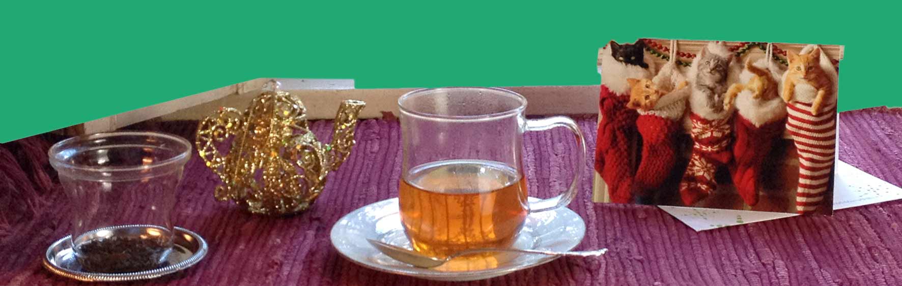 Keemun panda tea in clear glass cup, teapot tree ornament and Christmas card