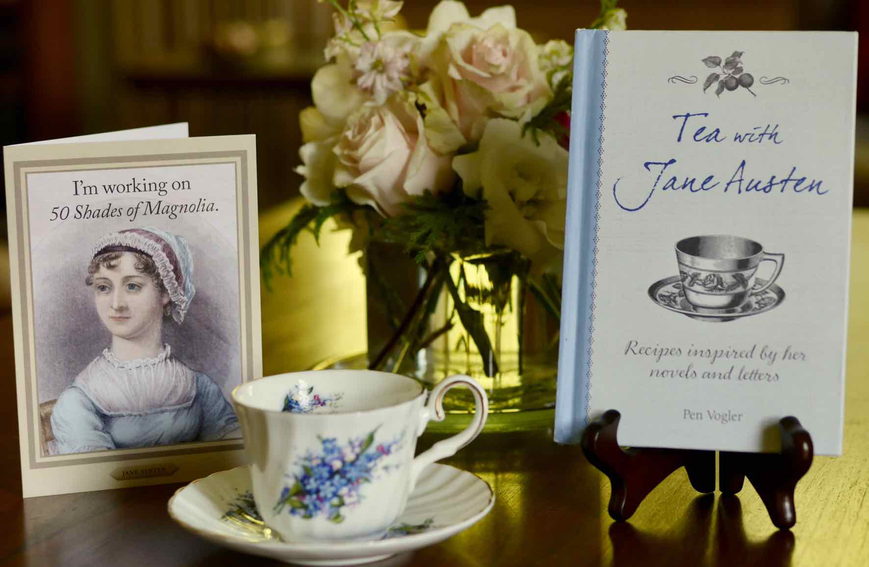 book Tea With Jane Austen by Pen Vogler, Jane Austen themed birthday card, tea cup and flower arrangement