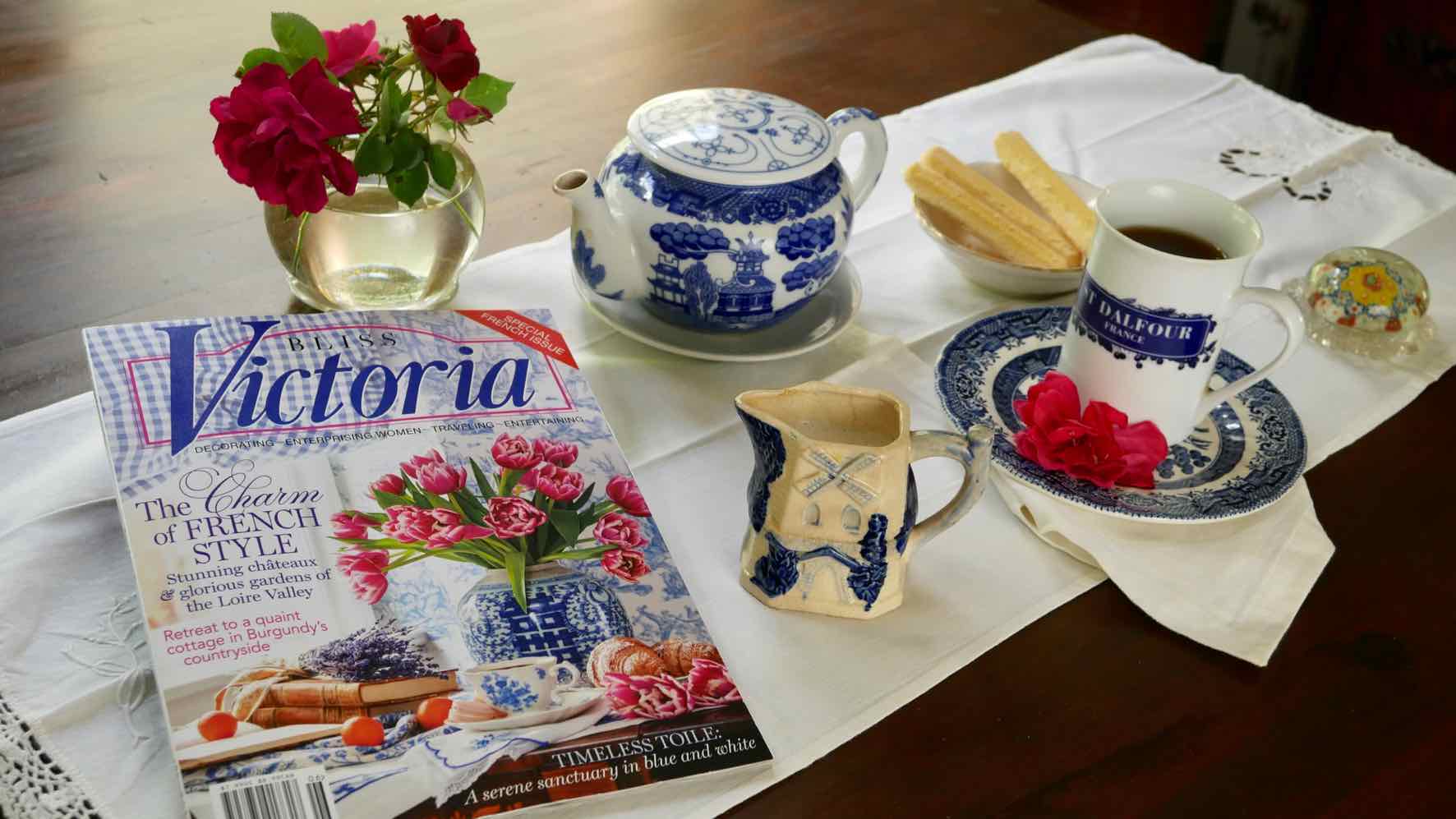 Victoria Magazine Special Issue 2020 with blue and white tea assessories and vase of red roses