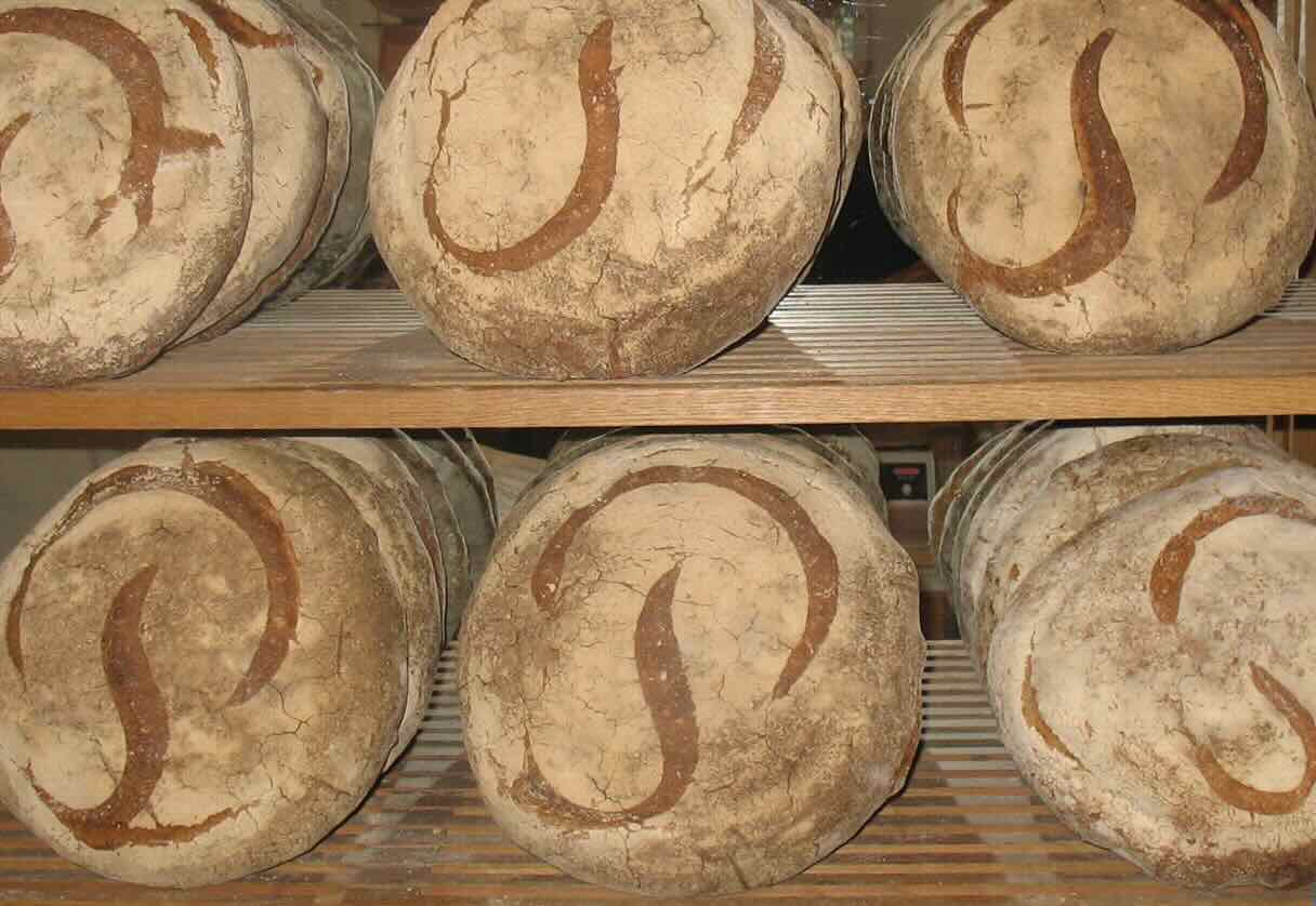 Loaves of Poilâne bread in bakery window. Photo by Gilbert Bochenek via Wikimedia