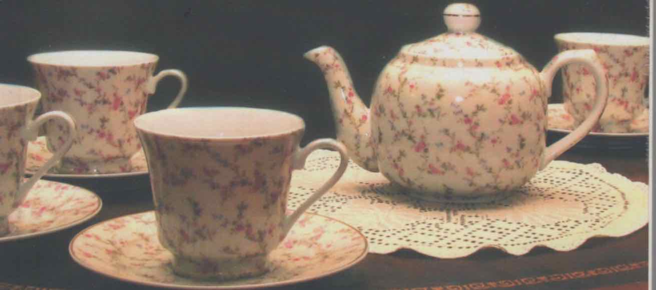 flowered china teapot and cups on lace