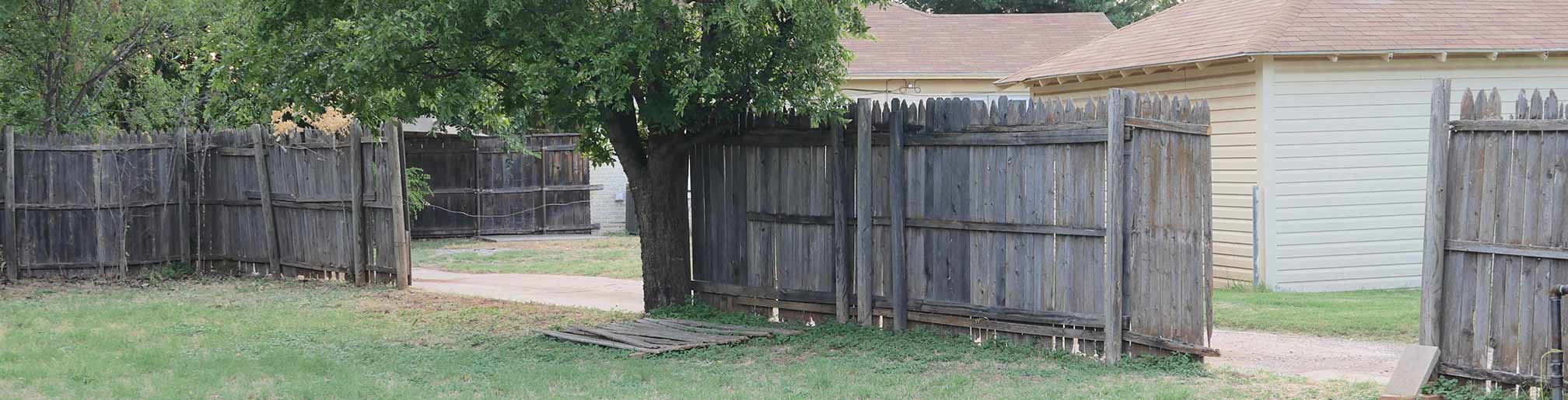 Anne's old fence at back of property along the alley. Damaged by garbage truck and storm.