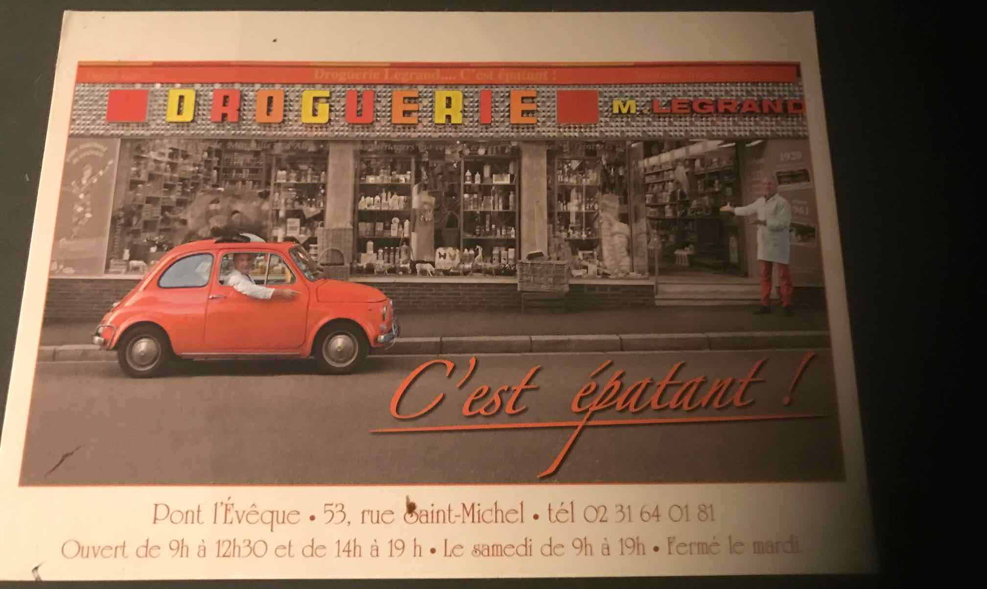 French drug store with two owners, one in small orange car
