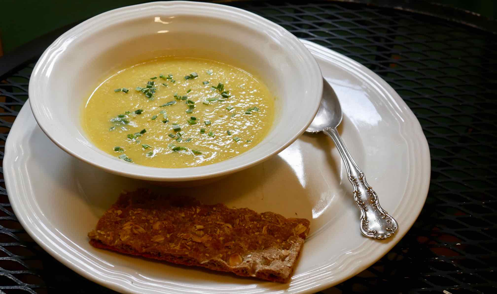 Soup made with large yellow squash garnished with chopped chives