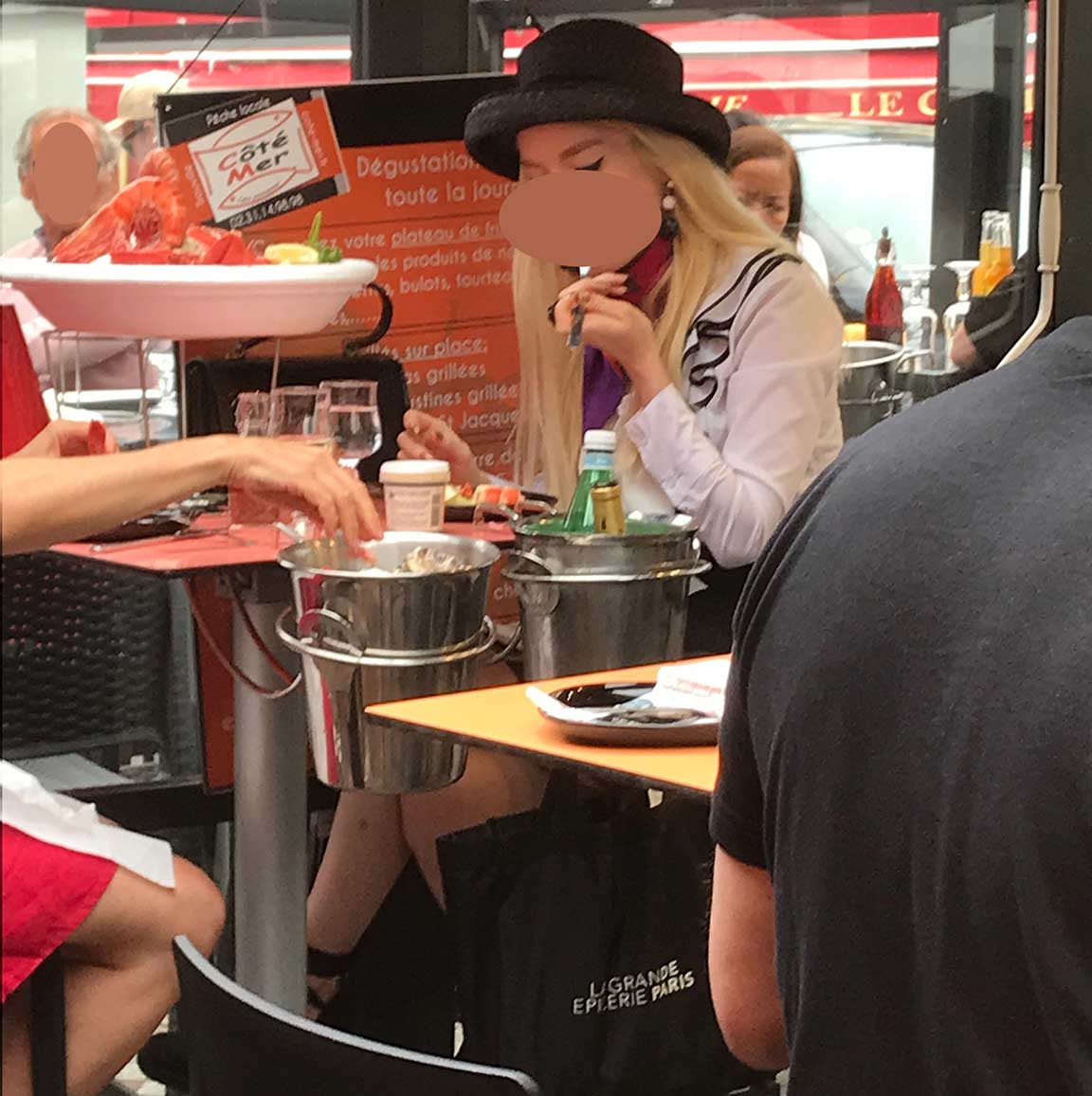 chic young woman eating seafood in restaurant