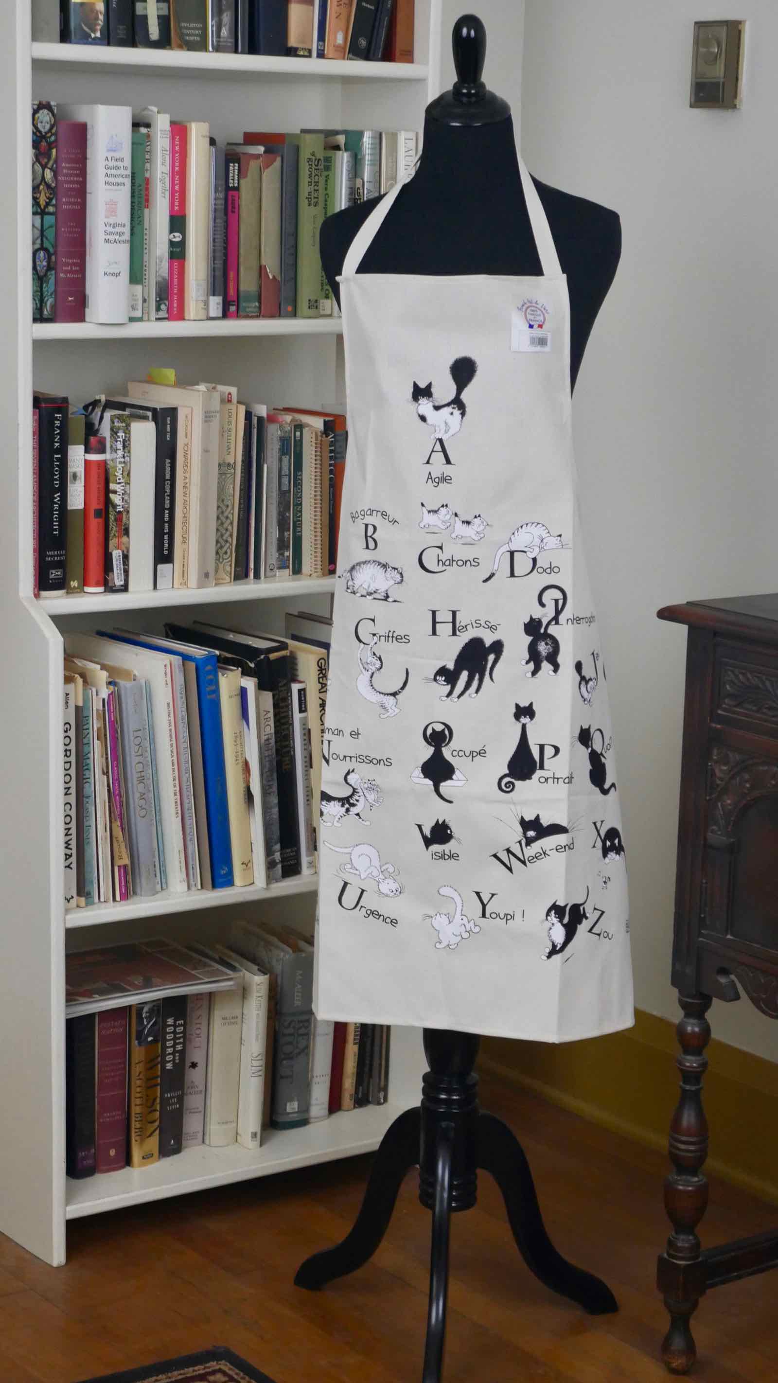 French cat alphabet apron between bookcase and sideboard