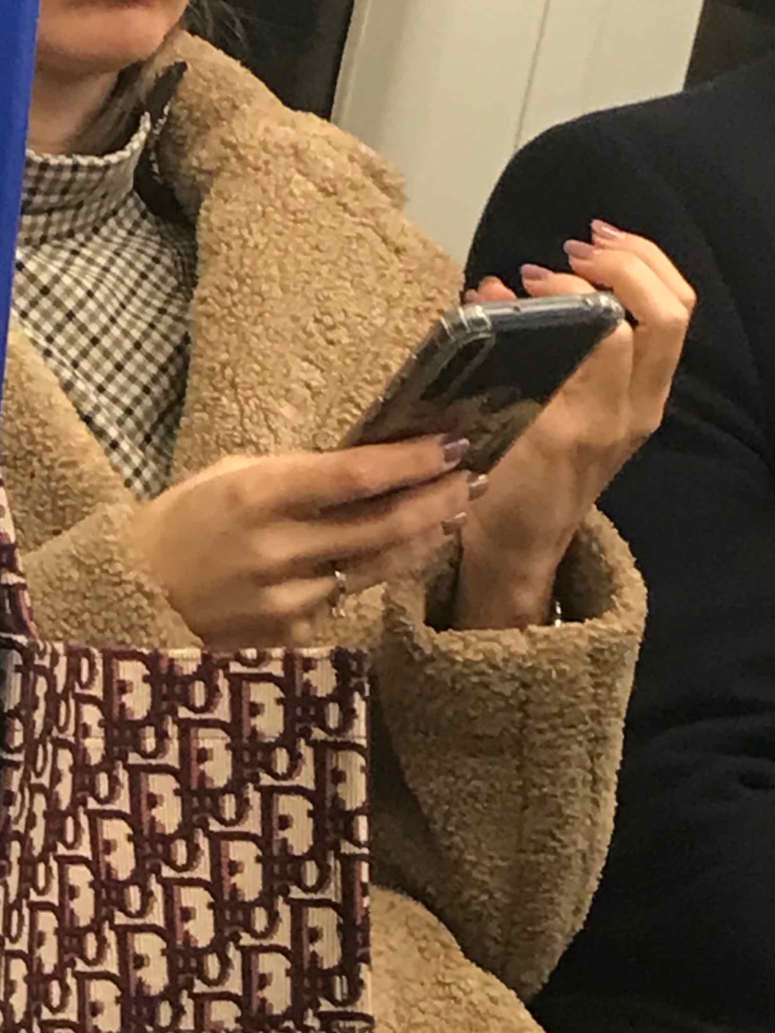 close-up of hands  with nail polish of chic woman wearing browns