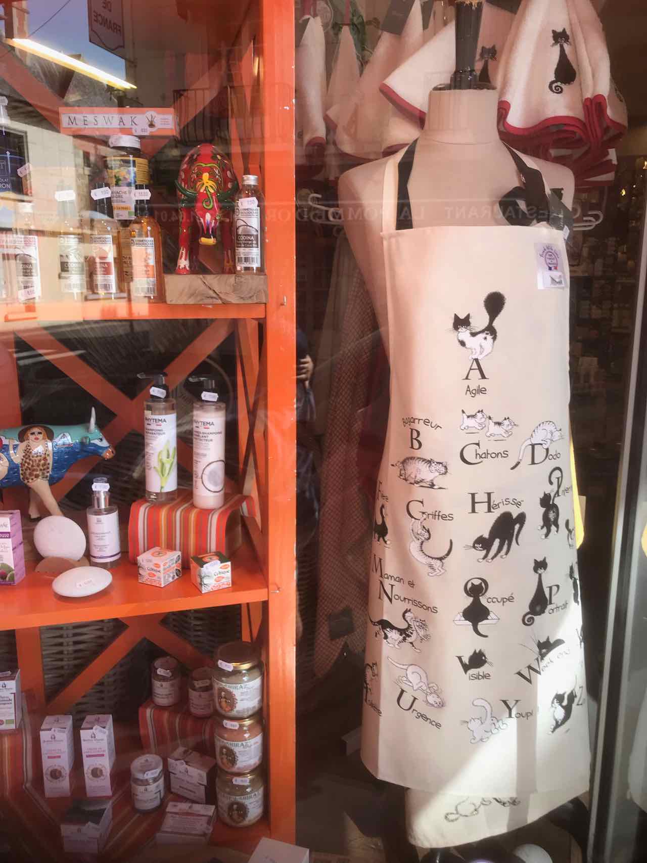 French cat alphabet apron in window of Droguerie Legrand