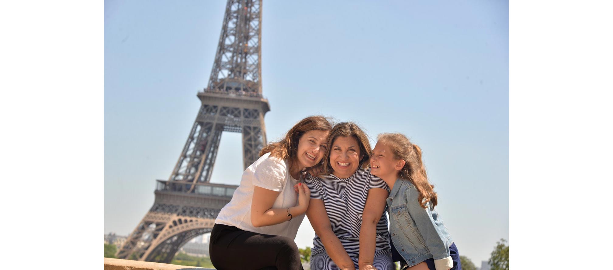 chic mother and her two daughters in front of Eiffel Tower