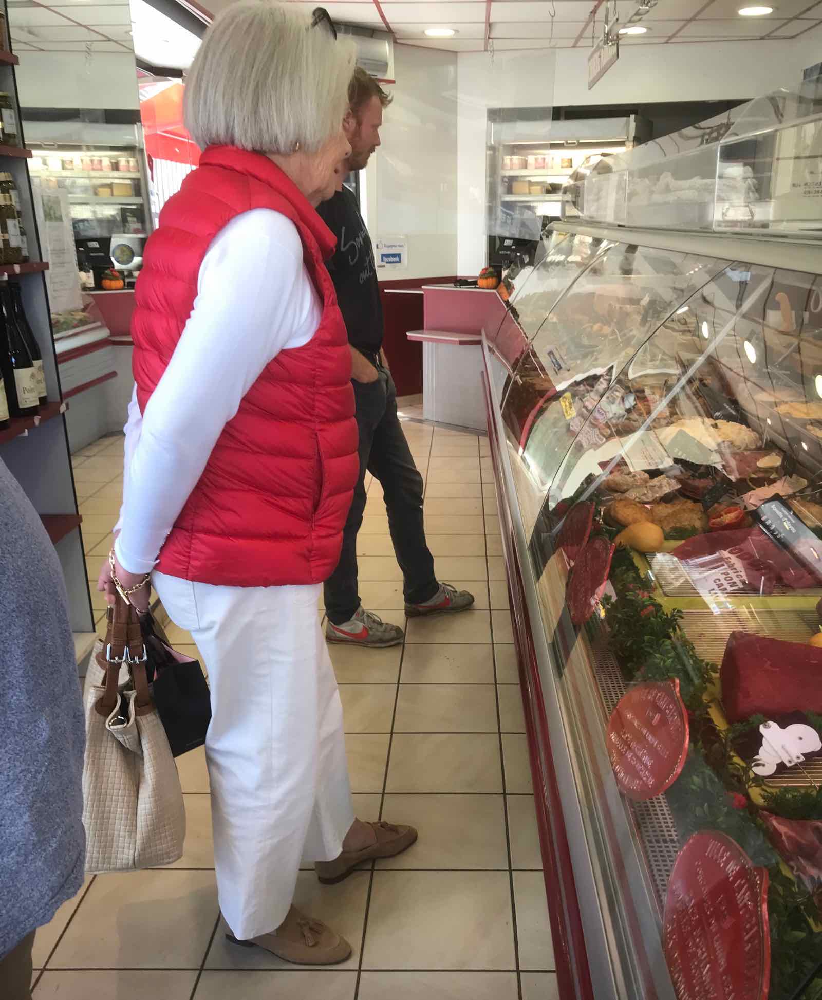 chic French Parisienne in white top and pants with red vest