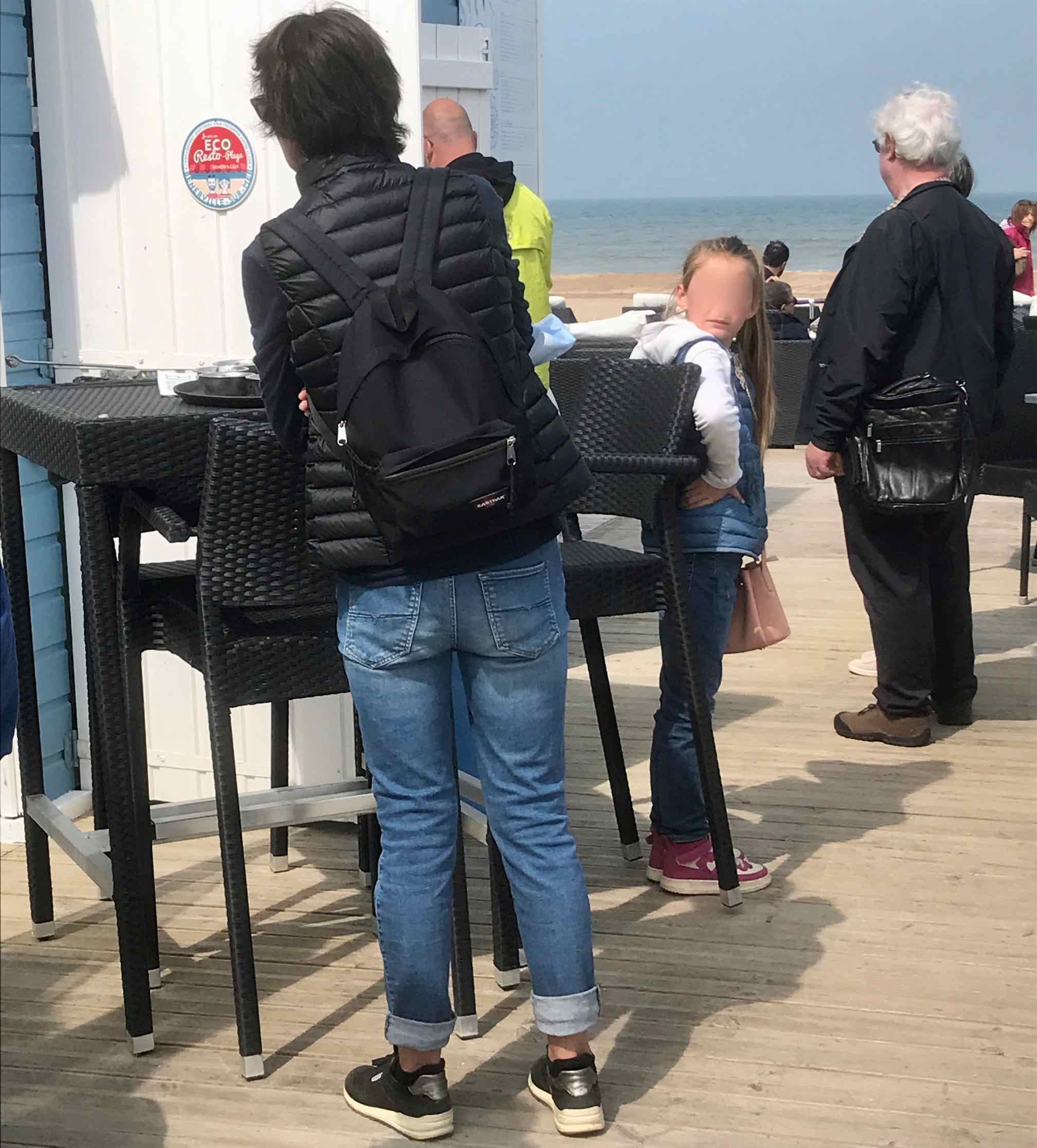 woman in line for buying ice cream at seaside resort